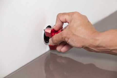 Hand using Heavy Duty Tungsten Carbide Scribing Tool Imperial Metric Gauge on laminate for precise cuts.