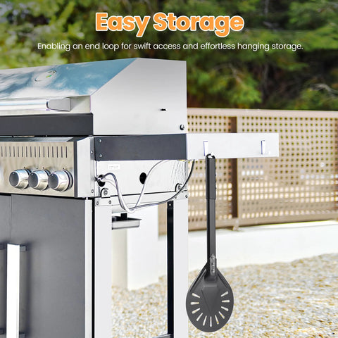 Side view of perforated aluminum pizza turning peel, dark gray, hanging from outdoor grill.