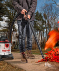 Man using 5 Gallon 4.5 Peak HP Wet Dry Vacuum With Stainless Steel Tank Portable Shop Vacuum outdoors to clear leaves