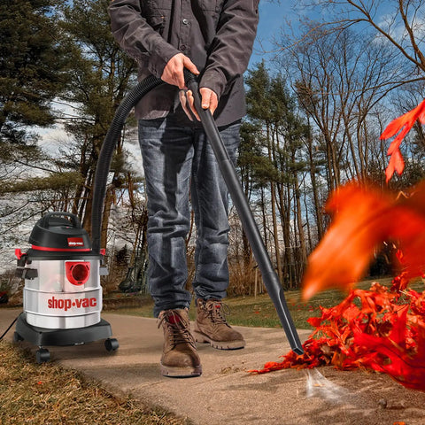 Man using 5 Gallon 4.5 Peak HP Wet Dry Vacuum With Stainless Steel Tank Portable Shop Vacuum outdoors to clear leaves