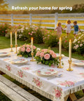 Outdoor table setting with floral tablecloth and 6 Pack Wax Flameless Taper Candles With Remote Timer And Dimmer for decor.