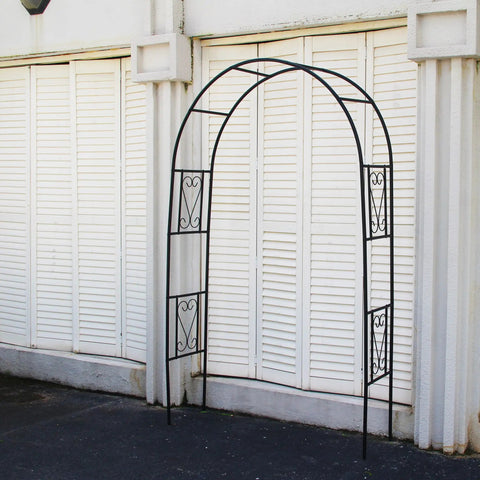 Powder Coated Iron Garden Pergola Arbor Built For Climbing Plants in front of a white wall, featuring decorative trellis design