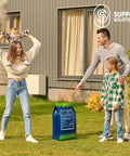 Family on lawn beside bag of Easy Spread Lawn Fertilizer With Iron For Deep Green Color And Stronger Roots Granular Turf Food For Spring Boost Even Coverage Across Your Yard 12 0 8 NPK With Iron For Rich Green Growth And Tougher Grass.