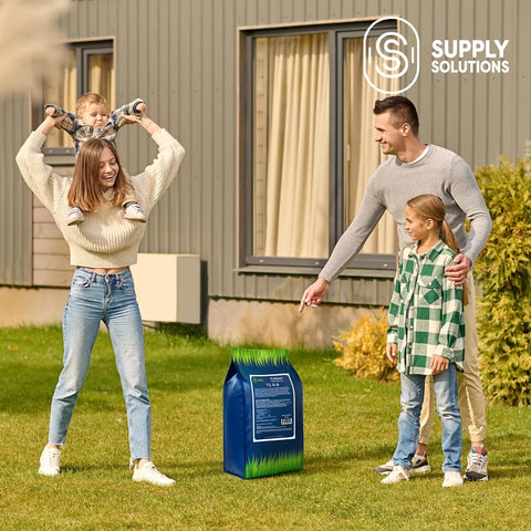 Family on lawn beside bag of Easy Spread Lawn Fertilizer With Iron For Deep Green Color And Stronger Roots Granular Turf Food For Spring Boost Even Coverage Across Your Yard 12 0 8 NPK With Iron For Rich Green Growth And Tougher Grass.