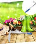 Garden scene with Stainless Steel Gardening Hoe With Anti Skid Rubber Grip Lightweight Yet Sturdy Hand Tool beside flowers and boots.