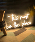 Large LED Neon Sign This Must Be The Place Wall Decor with warm white glow, adjustable brightness, 21.65 x 12.4 inches, for home decor.
