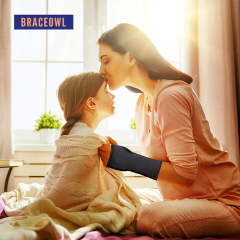 Woman wearing Carpal Tunnel Wrist Brace Adjustable Night Splint for Pain Relief From Tendonitis and Arthritis, comforting child.