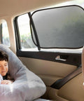 Child sleeping in car beside 2 Pack Car Window Sun Shades For Kids, UPF 50+ UV Block, 14.2 By 21.3 Inches, Static Cling Privacy Covers