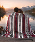 Couple by lake wrapped in Authentic Handmade Falsa Baja Blanket Soft And Lightweight Mexican Throw for outdoor gear, 70x50 Cherry.