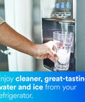 Person using refrigerator with Inline Water Filter For Refrigerators Ice Makers And Drinking Fountains That Cuts Chlorine Taste