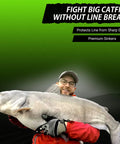 Angler holding large catfish, showcasing Flat No Roll Lead Sinkers With Line Protecting Inserts For River Fishing Built To Guard Your Line
