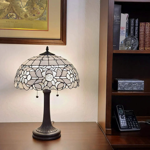 Vintage Tiffany Style Stained Glass Table Lamp 22 Inch Tall With White And Gray Mahogany Floral Shade For Bedside Living Room Bedroom Decor Handmade Gift LED Compatible Amora Lighting on wooden desk with bookshelf in background.