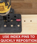 Milescraft CabinetMate shelf-pin drilling jig, black base with multiple holes and pink 1/4 insert, drill in use.