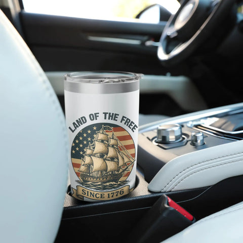 Patriotic Stainless Steel Insulated Tumbler With US Flag Sailboat Design in a car cup holder, keeps drinks cold or hot.