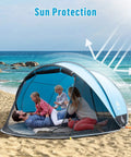 Pop Up Beach Tent For 2 To 4 People Large Sun Shade Shelter With Instant Setup No Poles Or Tools on sandy beach with family inside.