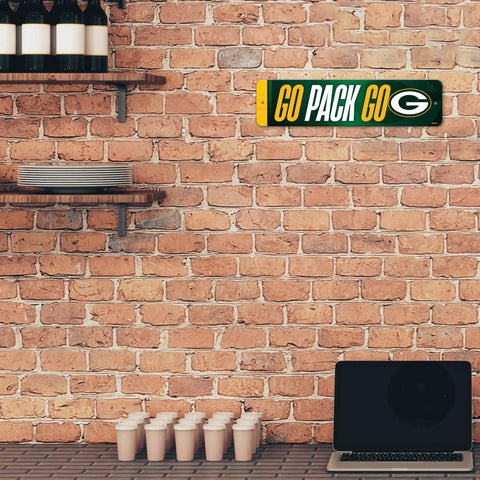Premium Green Bay Packers Metal Street Sign Wall Art Featuring Bold Team Graphics And Rust Resistant Finish Ideal For Man Cave Bedroom Or Home Office Decor displayed on a brick wall.