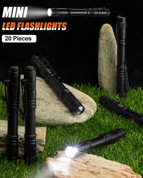 20 Pack Pen Light Flashlights, 5.12 Inch Aluminum Pocket LED Lights With Clip, displayed on grass and rocks, waterproof design