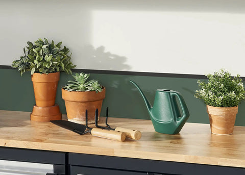 Tempered Steel Hand Trowel With Wood Handle 13 Inch Garden Tool beside plants in clay pots on a wooden table
