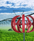 4500W Vertical Axis Wind Turbine Kit For Home Off Grid Power, 5 Blade 12V Generator, installed in a green field, red color.