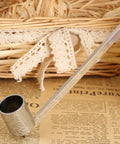Bad Boy Stainless Steel Candle Snuffer With Super Long Handle And Slick Silver Plating on wooden surface, close-up shot.