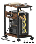 Two Tier Computer Tower Stand With Charging Station holding a PC, headphones, and books with visible power strip and wheels