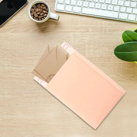 Heavy Duty Bubble Mailers 13x18 And 4 Inch Foam Padding on desk with coffee cup