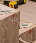 Close-up of Wine Red Wood Hole Plugs Set With 120 Pieces In Four Sizes Three Sixteenths Five Sixteenths Three Eighths And Half Inch installed on wood furniture, highlighting clean finish and installation.