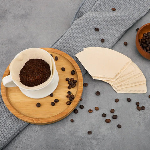 Mess Free Cone Coffee Filters 200 Count For 1 To 2 Cup Brewers Natural Unbleached Brown Paper Disposable Pour Over Basket Papers Fit Most Coffee Makers For Home Office And Cafe Use on a table with coffee beans.