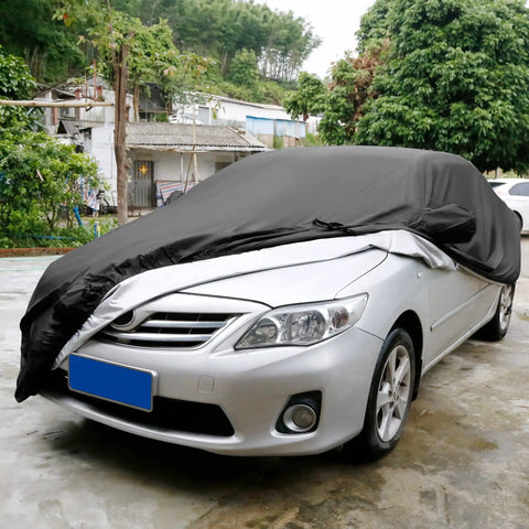 All Weather Waterproof Car Cover For Sedan Keeps Your Ride Protected From Rain And Sun Universal Fit With Windproof Straps And Buckle Bottom Easy On And Off 470 X 170 X 150 Cm shown on a silver sedan outdoors on a rainy day.