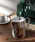 12 Oz Milk Frothing Pitcher Cup For Home Baristas, 350ml Stainless Steel Steaming Pitcher With Mirror Finish on a wooden table