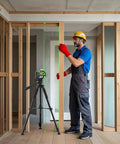 Worker using Dead Nuts True Self Leveling Green Laser Level Tough Cross Line Tool with Dual Plumb Dots in a construction setting.