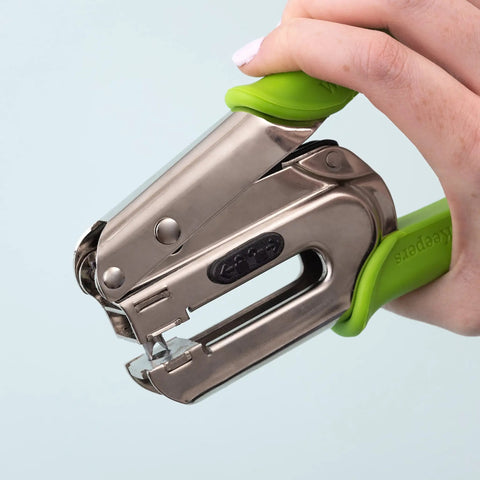 Hand holding Crop-A-Dile Power Punch For One Quarter Inch Holes Scrapbooking Tool That Delivers Clean Punches Through Paper Leather Fabric