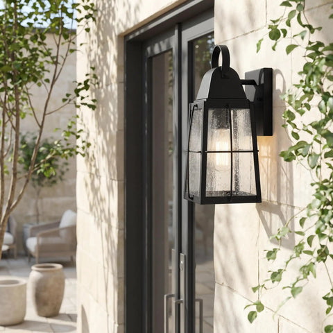 Tolerand 12 Inch Outdoor Wall Light In Textured Black With Clear Seeded Glass 1 Light Exterior Sconce mounted on stone wall