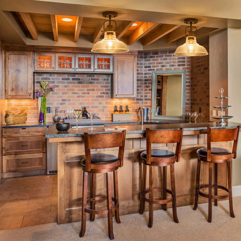 Cozy kitchen with farmhouse flush mount ceiling light with aged black metal frame and seeded glass shade, 3 wooden bar stools