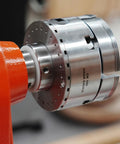 Pack Of Six Slick Anti Lock Spindle Washers Tailored For 1-1/4 Inch Woodlathe Threads mounted on a gear chuck with spindle.