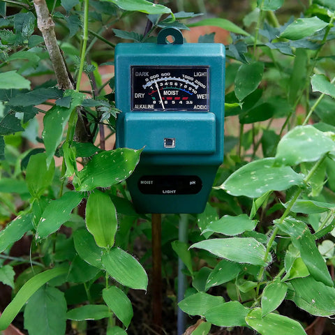 3 In 1 Soil Moisture Light And PH Tester for Indoor Outdoor Gardens Lawn Farm Greenhouse, no batteries, green casing in use among plants.