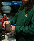 Man holding Oil Tan Leather Wallet For Men Durable Full Grain Leather Front Pocket Bi Fold Or Trifold Styles RFID Blocking