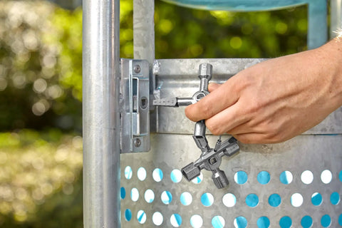 Hand using TwinKey Multifunctional Spanner Kit With Magnetic Eight Arm Two By Four Way Spider Keys on metal control cabinet