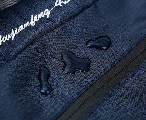 Close-up of water droplets on navy 50L Hiking Backpack For Men With Rain Cover Expandable 45L Plus 5L, showing waterproof material.