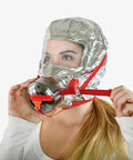 Woman wearing a fire emergency escape mask and hood for smoke and carbon monoxide protection, 30 minute respirator shield during fire evacuations.
