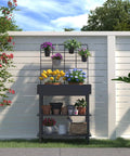 Metal Raised Garden Bed With Trellis And 2 Tier Storage Shelf on patio, displaying potted flowers with climbing plants