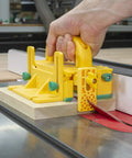 Kickback Buster 3D Push Block With Gravity Heel Kit For Table Saws in use, securely holding lumber on a table saw.