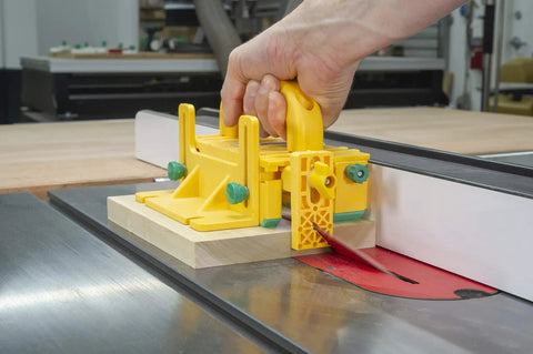 Kickback Buster 3D Push Block With Gravity Heel Kit For Table Saws in use, securely holding lumber on a table saw.