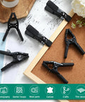 Kickass Heavy Duty Spring Clamps A Twenty Four Pack Delivering Snug One Point Five Inch Openings And Secure Non Slip Handles All Black Tooling on cork board.