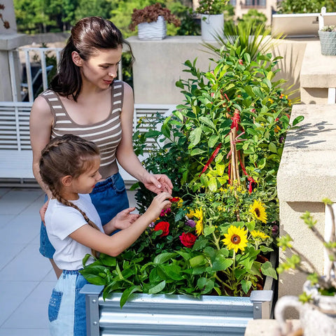 Mother and daughter tending plants in Galvanized Raised Garden Bed With Legs 48 By 24 By 32 Inch Elevated Planter Box With Drainage Holes