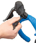 Hand using EWS1 Electronics 3 Way Tool For Bike Systems With Angled Di2 E Tube Ends For Tight Space Install And Removal, Universal Coin Cell Battery