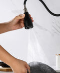 Top Shelf Slick Pull Down Kitchen Faucet Sprayer Head Replacement In Matte Black with heavy-duty connectors, spraying water over a dish.