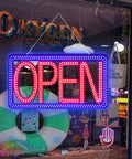 Storefront window with 16.5 By 9 Inch Horizontal LED Open Sign For Biz, Ultra Bright And Dimmable Store Sign Displayed