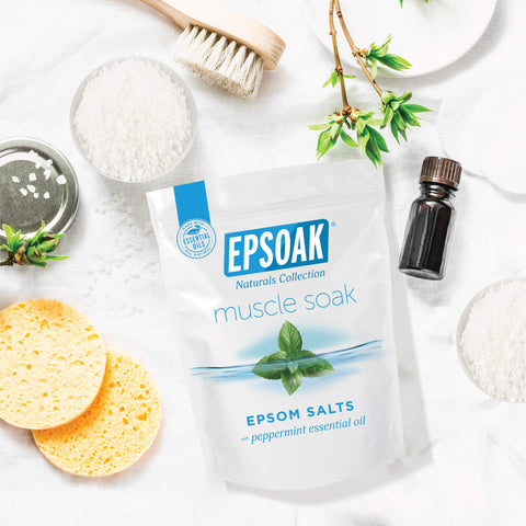 Muscle Recovery Epsom Salt Soak With Eucalyptus And Peppermint Essential Oils, 12 Lbs Total, Six Two Pound Bags shown with bath items.