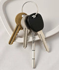 Compact 4 Piece Mini Eyeglass Screwdriver Set With 3 In 1 Flathead And Phillips Drivers attached to keychain with keys on tray